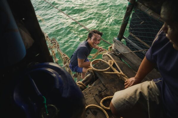 Smiling Man Holding Ropes over Water